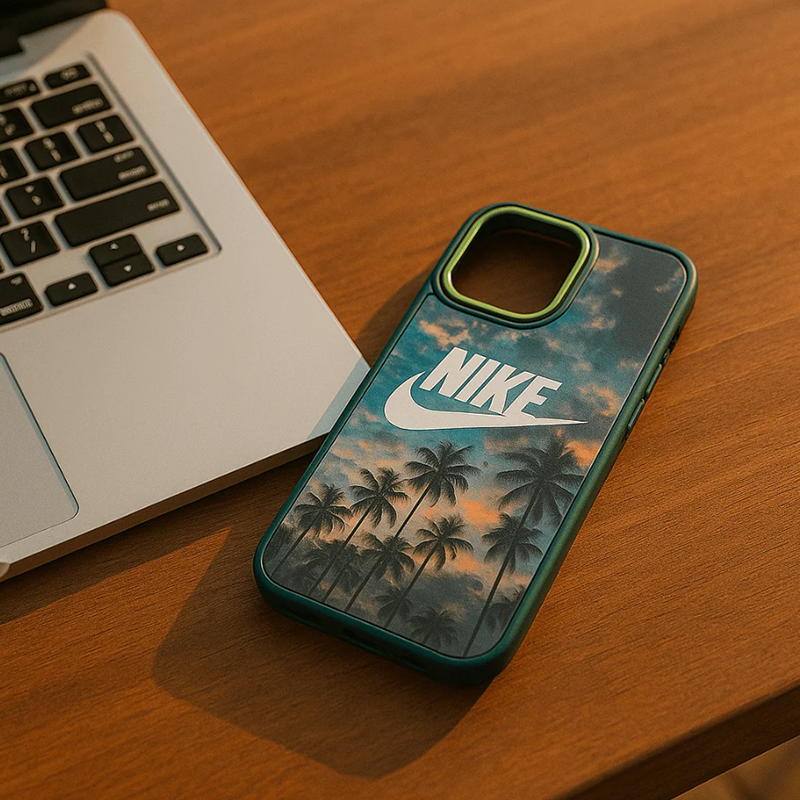 Phone case with Nike logo on a wooden desk next to a laptop